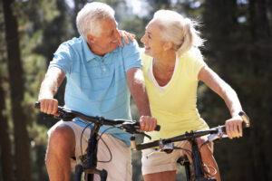 Elderly people riding bikes together enjoying their lifestyle